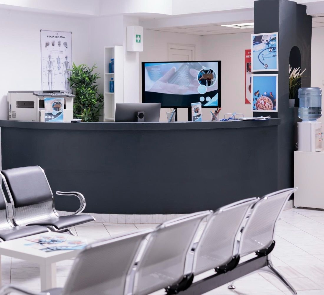 A clean, modern clinic reception area with waiting seats
