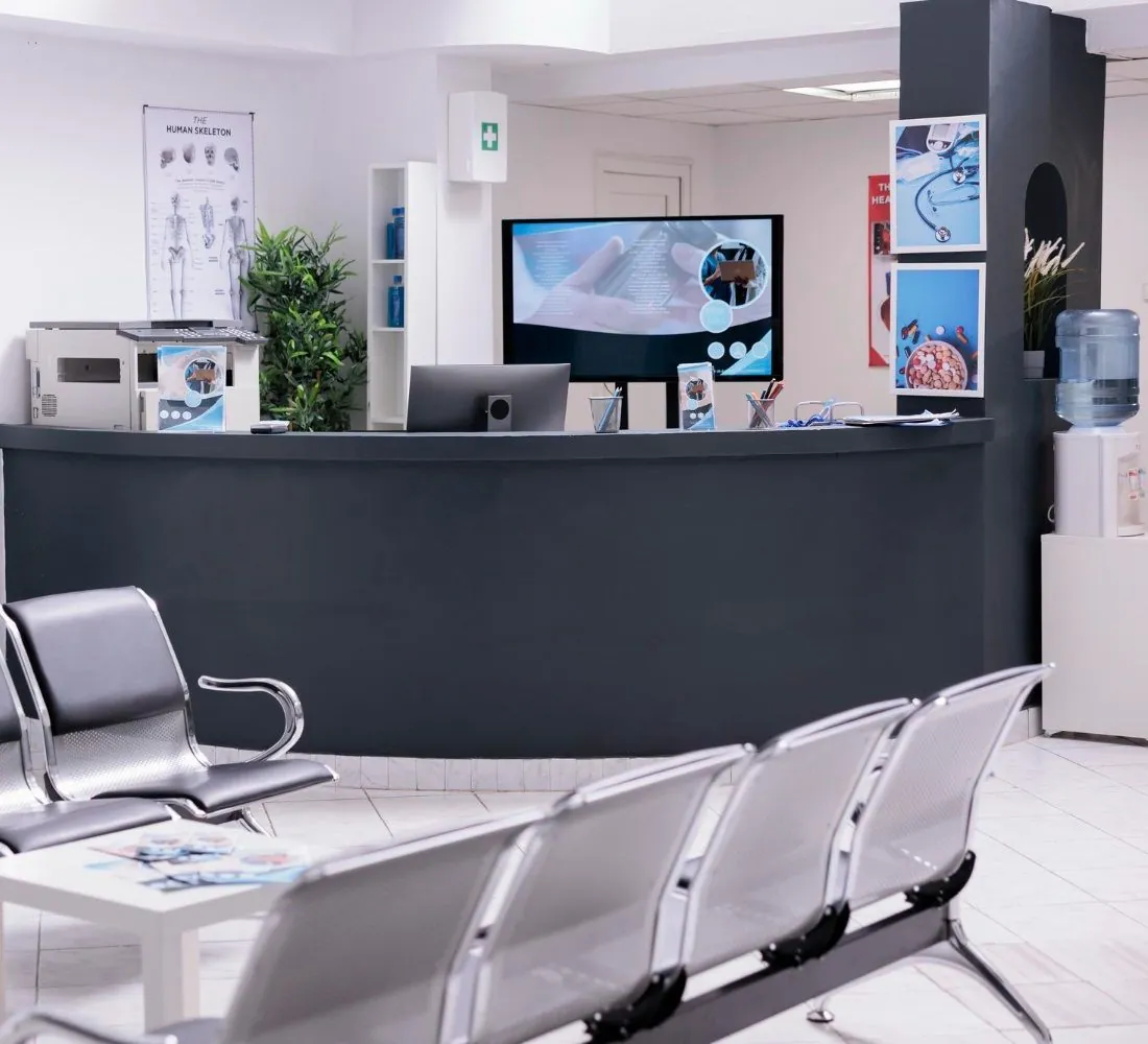 A clean, modern clinic reception area with waiting seats