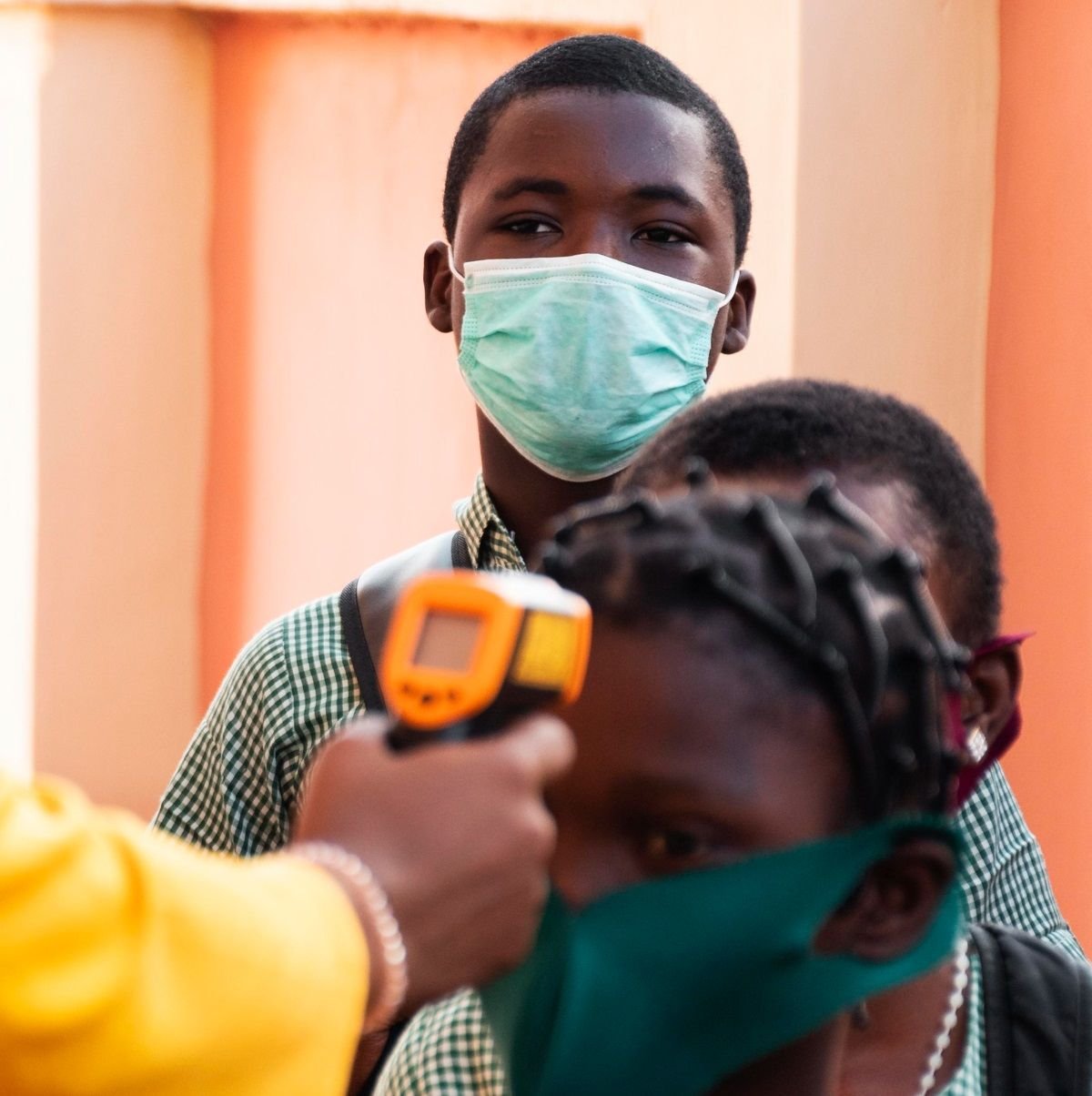A health worker screens students during a community public health check