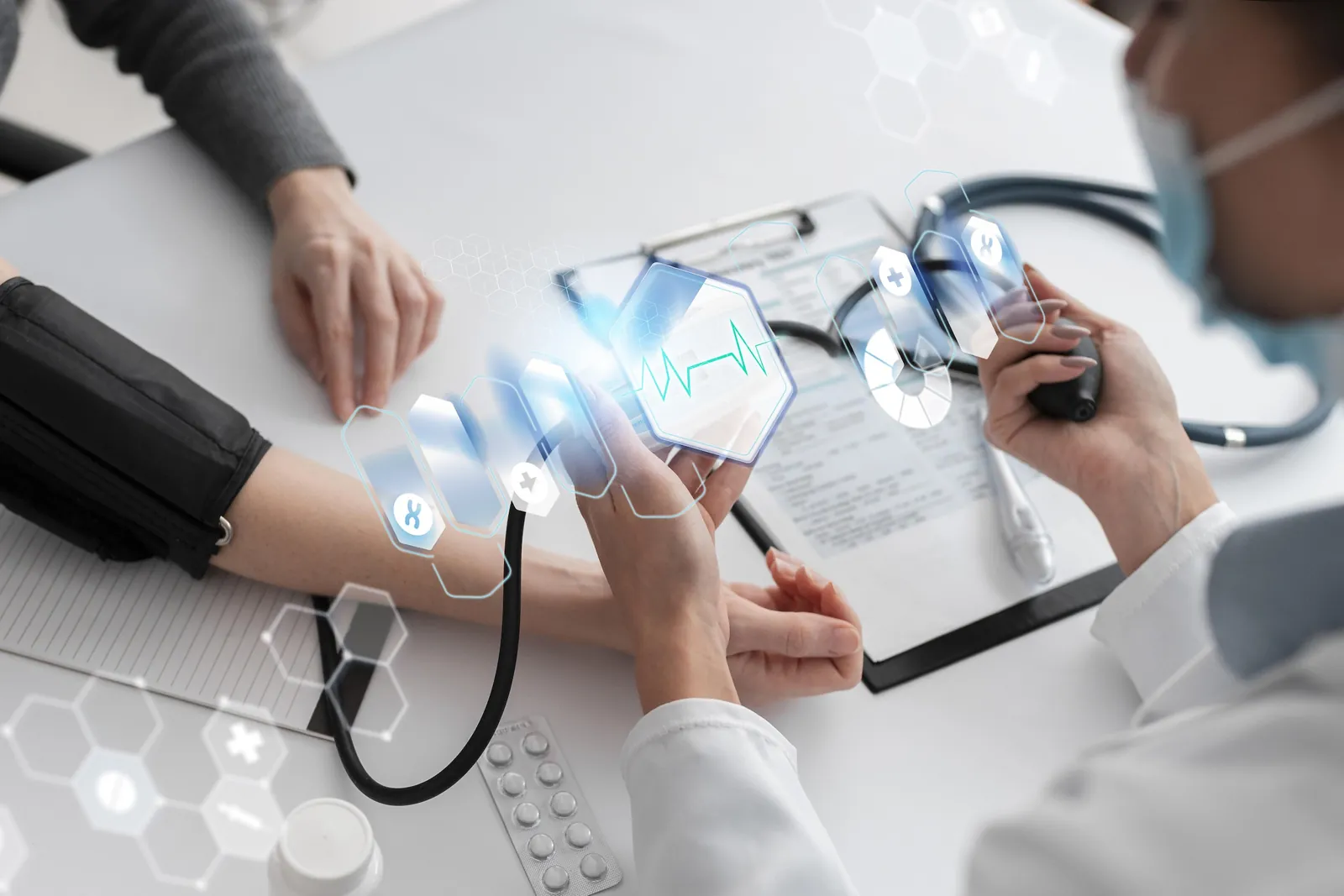 A clinician takes a patient’s blood pressure as digital vital-sign readings appear above the table