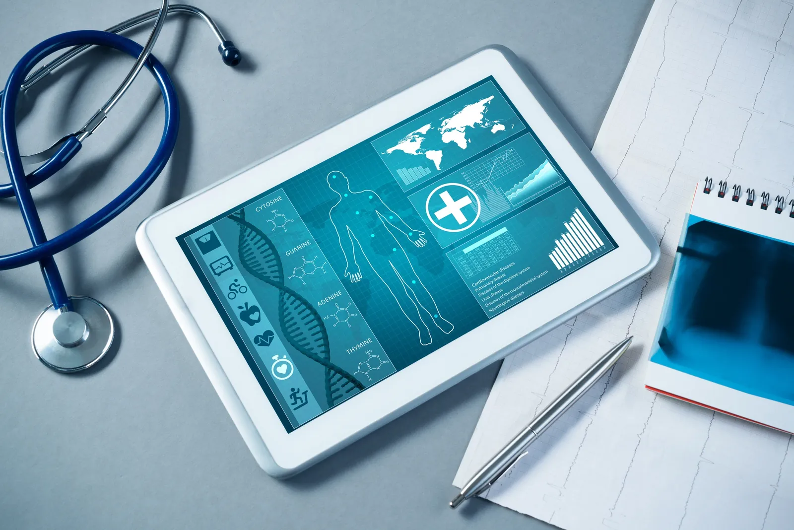 A tablet showing a digital health dashboard beside a stethoscope